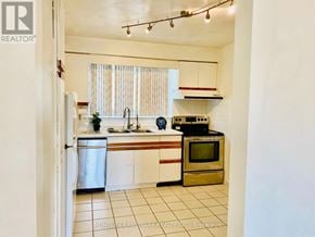 Toronto (L'amoreaux) townhouse for rent - A kitchen with white cabinets and a stainless steel refrigerator.
