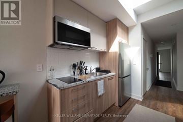 Toronto (Kensington-Chinatown) apartment for rent - A kitchen with a granite countertop and a stainless steel sink.
