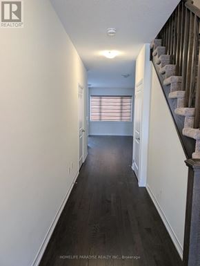 Cambridge townhouse for rent - A hallway with a staircase on the right side.