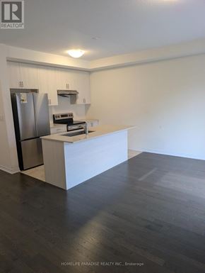 Cambridge townhouse for rent - A kitchen with a refrigerator, stove, and oven.