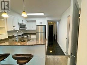 Toronto (Waterfront Communities) condo for rent - A kitchen with a marble countertop and modern appliances.