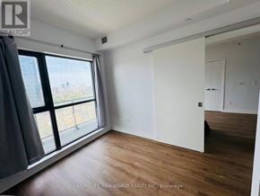 Toronto (Church-Yonge Corridor) condo for rent - A room with a large window and wooden flooring.