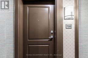 Hamilton (Waterdown) condo for rent - A brown door with a glass window and a number 708 on the wall.