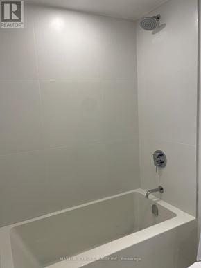 Toronto (Bay Street Corridor) condo for rent - A white bathroom with a tub and shower.