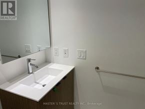 Toronto (Bay Street Corridor) condo for rent - A bathroom with a sink, mirror, and light switches.