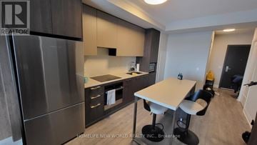 Markham (Unionville) condo for rent - A kitchen with a table and chairs in the middle of the room.