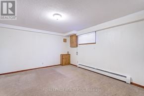 Toronto (Humberlea-Pelmo Park) apartment for rent - A white wall with a brown door and a window with blinds.