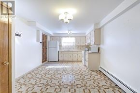 Toronto (Humberlea-Pelmo Park) apartment for rent - A kitchen with a tiled floor and white walls.