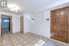 Toronto (Humberlea-Pelmo Park) apartment for rent - A room with a wooden door and a tiled floor.