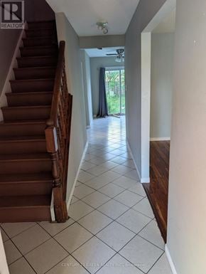 London South (South X) apartment for rent - A hallway with a staircase on the left and a doorway on the right.