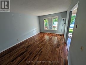 London South (South X) apartment for rent - A room with wooden flooring and a window overlooking a balcony.