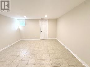 Toronto (Newtonbrook East) apartment for rent - A room with a white door and tiled floor.