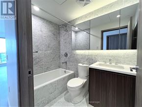 Toronto (Bayview Village) condo for rent - A bathroom with a tub, toilet, and sink.
