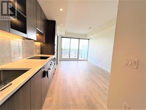 Toronto (Bayview Village) condo for rent - A modern kitchen with dark wood cabinets and a marble backsplash.