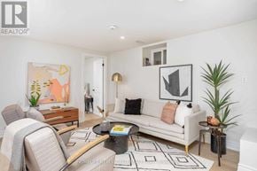 Toronto (Dovercourt-Wallace Emerson-Junction) apartment for rent - A living room with a couch, chair, and a painting on the wall.