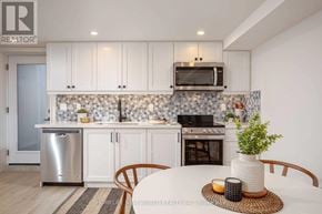 Toronto (Dovercourt-Wallace Emerson-Junction) apartment for rent - A modern kitchen with white cabinets and a stainless steel dishwasher.