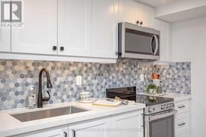 Toronto (Dovercourt-Wallace Emerson-Junction) apartment for rent - A kitchen with a stove, sink, and cabinets.