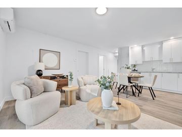 Gatineau (Gatineau) apartment for rent - A living room with a white couch, a wooden coffee table, and a dining table with chairs.