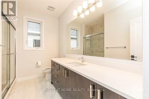 Ottawa apartment for rent - A bathroom with a marble counter top and a large mirror.