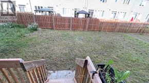 Ottawa apartment for rent - A backyard with a wooden fence and two chairs.