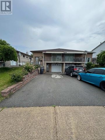 Mississauga (Malton) apartment for rent - A kitchen with white cabinets and black countertops.