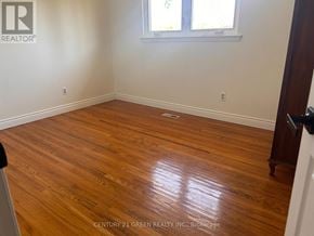 Mississauga (Malton) apartment for rent - A room with wooden flooring and a window.