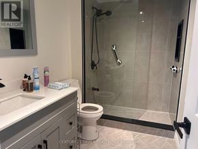 Mississauga (Malton) apartment for rent - A bathroom with a toilet, sink, and shower.