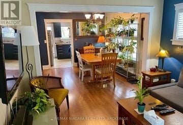 St. Catharines (Downtown) apartment for rent - A well-lit living room with a dining table and chairs.