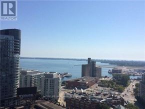 Toronto (Waterfront Communities) condo for rent - A cityscape with a body of water in the distance and a sign that says "REALTOR".