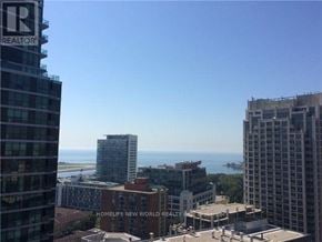 Toronto (Waterfront Communities) condo for rent - A cityscape with buildings and a clear sky.