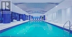 Toronto (Willowdale West) condo for rent - A large indoor swimming pool with a blue tint.