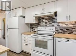 Mississauga (Mississauga Valleys) condo for rent - A kitchen with white appliances and cabinets.