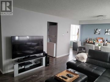 Mississauga (Mississauga Valleys) condo for rent - A living room with a television and a black leather couch.