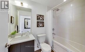 Toronto (Woodbine Corridor) condo for rent - A realtor office with a glass wall and a white couch.