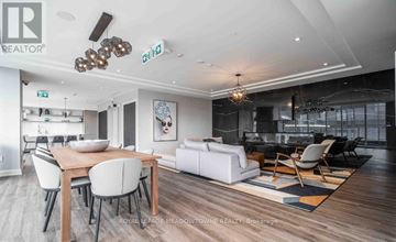 Hamilton (Beasley) condo for rent - A modern living room with a dining table and chairs.