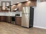 Vaughan (Patterson) apartment for rent - A kitchen with a refrigerator, oven, and cabinets.