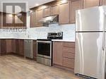 Vaughan (Patterson) apartment for rent - A kitchen with a white refrigerator and wooden floors.