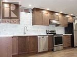 Vaughan (Patterson) apartment for rent - A kitchen with wooden cabinets and stainless steel appliances.