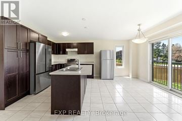Kawartha Lakes (Lindsay) apartment for rent - A kitchen with dark brown cabinets and a white countertop.