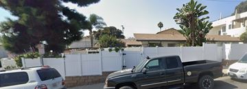 San Clemente apartment for rent - A black truck is parked in front of a white fence.