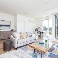 Victoria apartment for rent - A living room with a grey couch and a wooden coffee table.