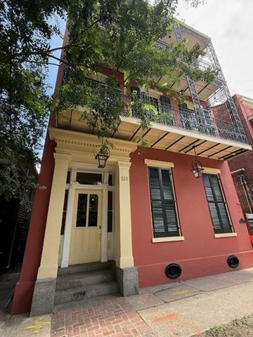New Orleans apartment for rent - A red building with a white door and windows.