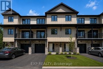 Russell townhouse for rent - A large, modern two-story house with a balcony on the second floor.