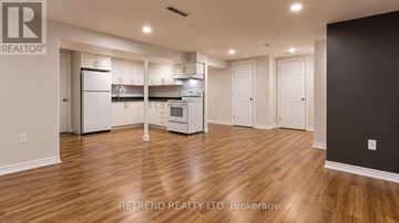 Toronto (Tam O'shanter-Sullivan) apartment for rent - A kitchen with white appliances and wooden floors.