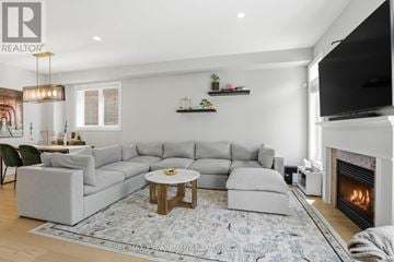 Hamilton (Winona Park) apartment for rent - A living room with a grey sofa set and a fireplace.