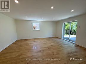 St. Catharines (Burleigh Hill) apartment for rent - A room with wooden flooring and a window letting in natural light.