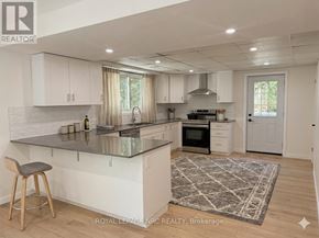 St. Catharines (Burleigh Hill) apartment for rent - A kitchen with a bar stool in front of it.