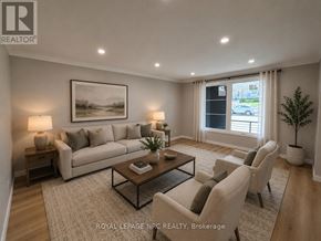 St. Catharines (Burleigh Hill) apartment for rent - A well-lit living room with a large sofa, a coffee table, and a painting on the wall.