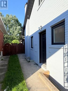 Mississauga (Applewood) apartment for rent - A white house with a black door and a window.