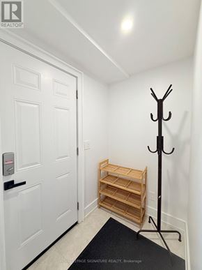 Mississauga (Applewood) apartment for rent - A white door with a black handle and a black coat rack with a coat hanging on it.